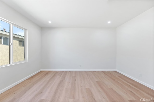 unfurnished room featuring light hardwood / wood-style floors and a healthy amount of sunlight