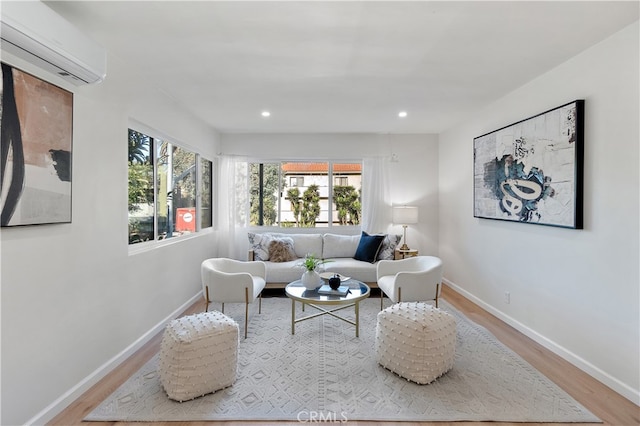 living room with light wood-type flooring and a wall unit AC