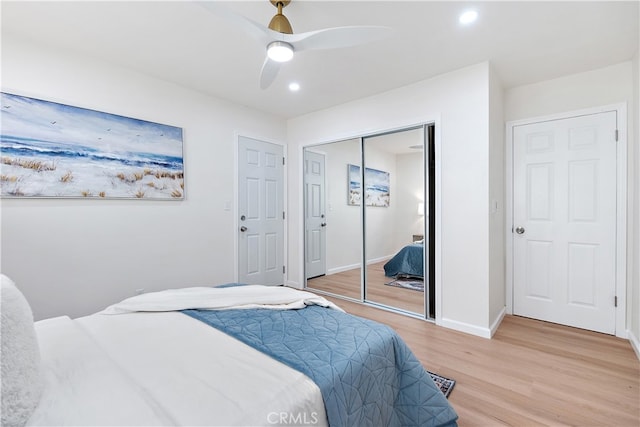 bedroom with ceiling fan and light wood-type flooring