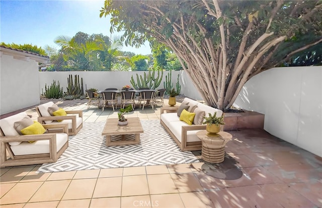 view of patio / terrace featuring an outdoor living space, outdoor dining area, and a fenced backyard