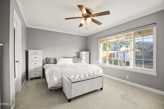 bedroom with light carpet, ceiling fan, and ornamental molding