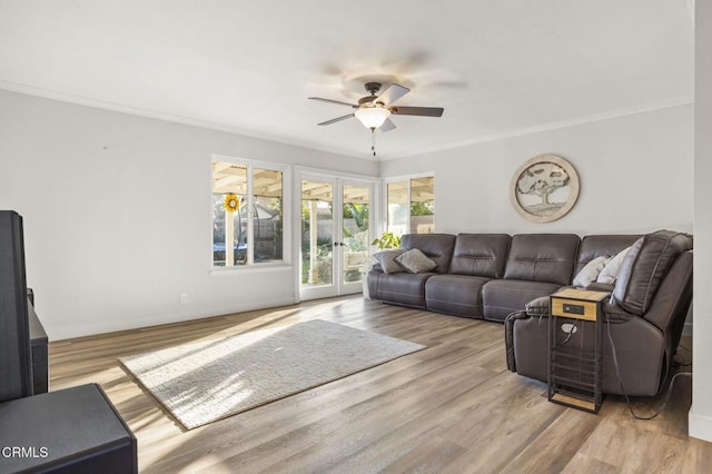 living room with french doors, light hardwood / wood-style flooring, ceiling fan, and ornamental molding