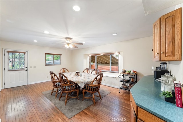 dining area featuring wood-type flooring and ceiling fan