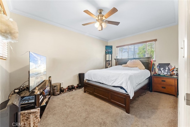 bedroom featuring ceiling fan, crown molding, and light colored carpet