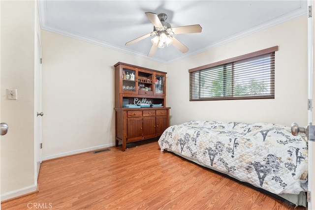 bedroom with ornamental molding, light hardwood / wood-style flooring, and ceiling fan