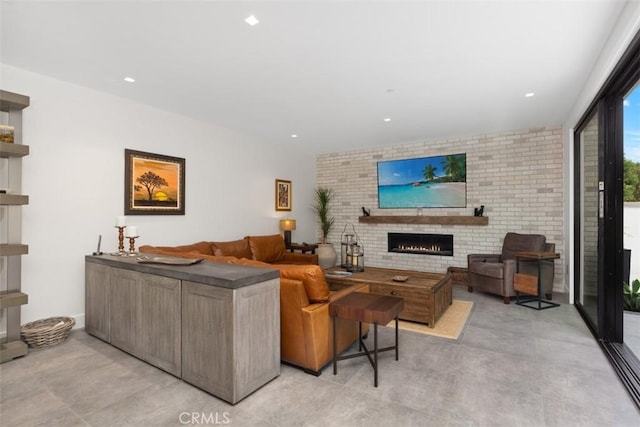 living room featuring a fireplace and brick wall