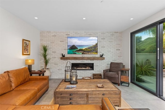 living room featuring brick wall and a brick fireplace