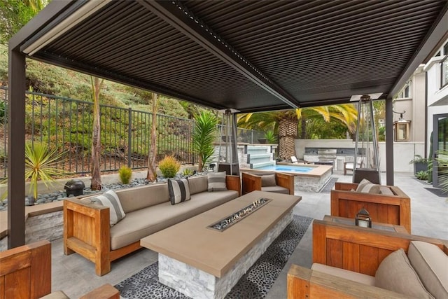 view of patio featuring area for grilling and an outdoor living space with a fire pit