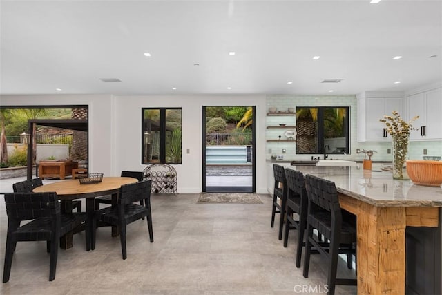 dining area with sink and a wealth of natural light