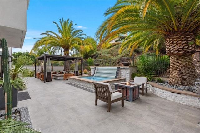 view of patio / terrace with an outdoor living space with a fire pit