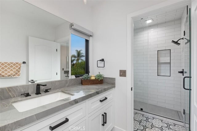 bathroom with vanity and a shower with door