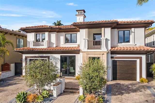 view of front of home featuring a balcony and a garage