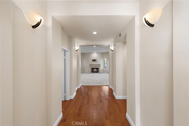 hallway with hardwood / wood-style floors