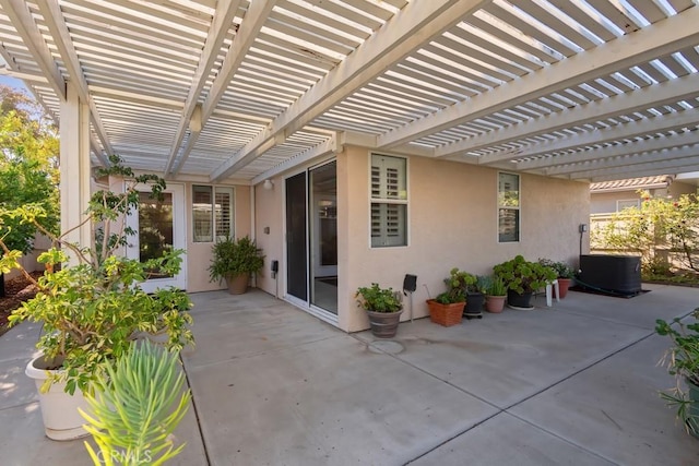 view of patio with a pergola and central AC