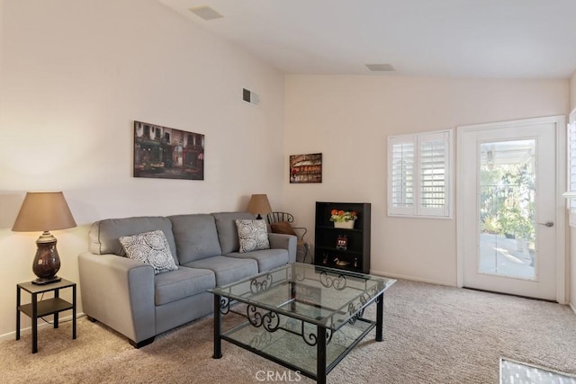 living room featuring light carpet and vaulted ceiling