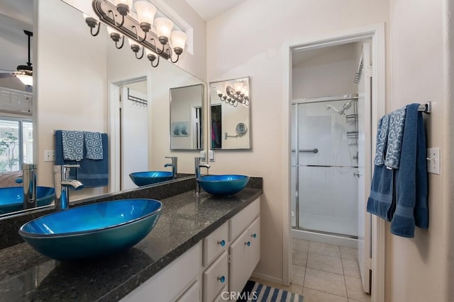 bathroom featuring tile patterned flooring, vanity, ceiling fan, and an enclosed shower