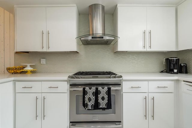 kitchen with stainless steel gas stove, wall chimney exhaust hood, backsplash, white dishwasher, and white cabinets