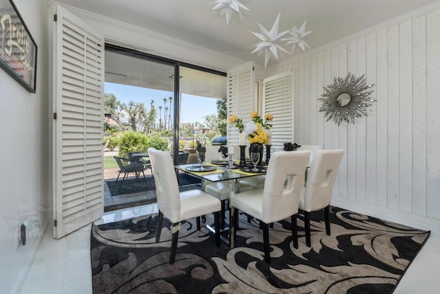 dining space with wood walls