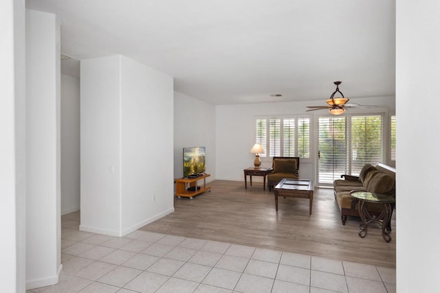 interior space with light wood-type flooring and ceiling fan