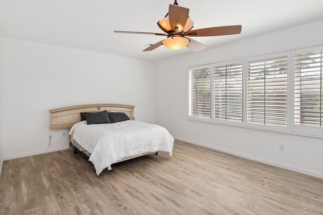 bedroom with hardwood / wood-style flooring and ceiling fan