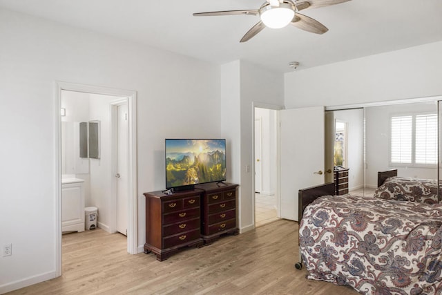 bedroom with ensuite bathroom, light wood-type flooring, and ceiling fan