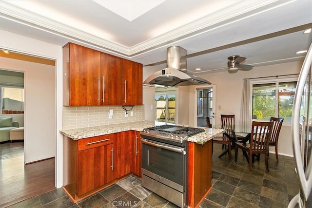 kitchen featuring tasteful backsplash, island range hood, light stone countertops, stainless steel range with gas cooktop, and kitchen peninsula