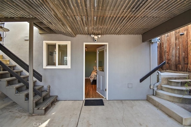 view of exterior entry with a patio area