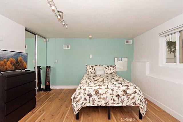 bedroom with a closet and light hardwood / wood-style flooring