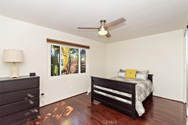 bedroom with ceiling fan and dark hardwood / wood-style floors