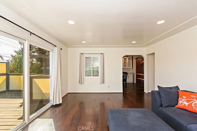 unfurnished living room with dark hardwood / wood-style floors and a healthy amount of sunlight