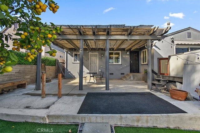 rear view of house featuring a patio and a pergola