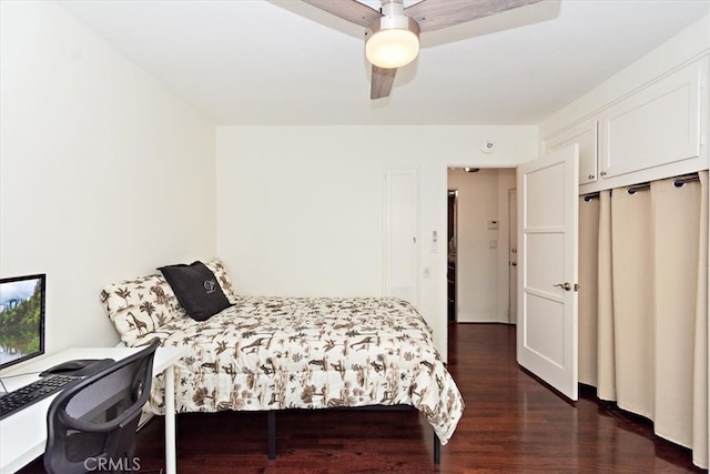 bedroom with dark hardwood / wood-style floors and ceiling fan