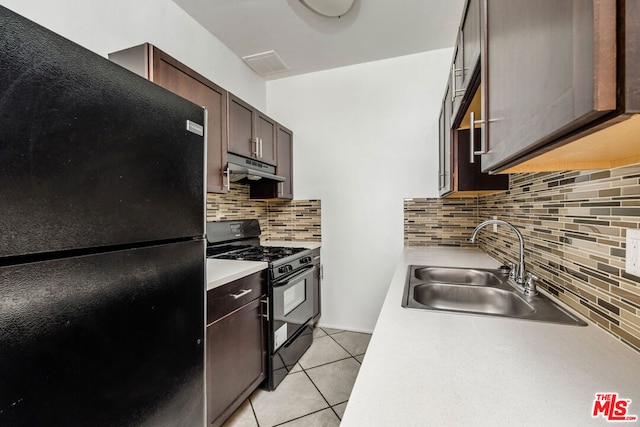 kitchen with tasteful backsplash, sink, black appliances, and dark brown cabinets