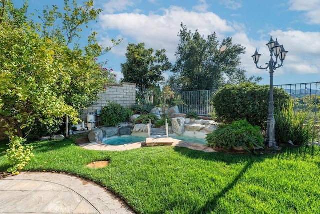 view of yard with pool water feature and a hot tub