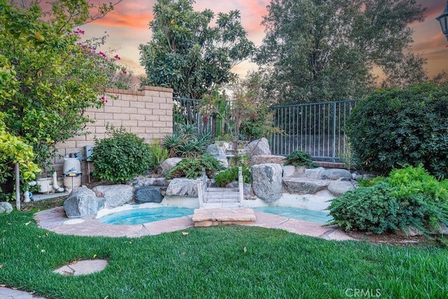 view of yard at dusk