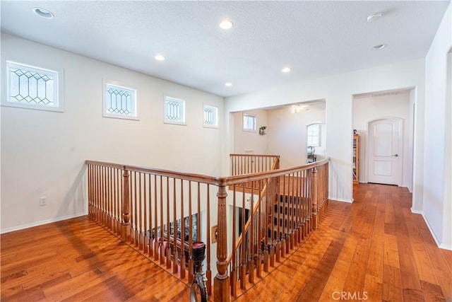 hall featuring hardwood / wood-style flooring and a textured ceiling