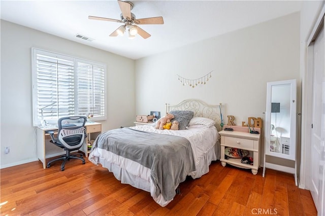 bedroom featuring ceiling fan, a closet, and hardwood / wood-style flooring