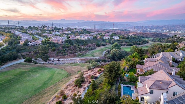 aerial view at dusk featuring a mountain view