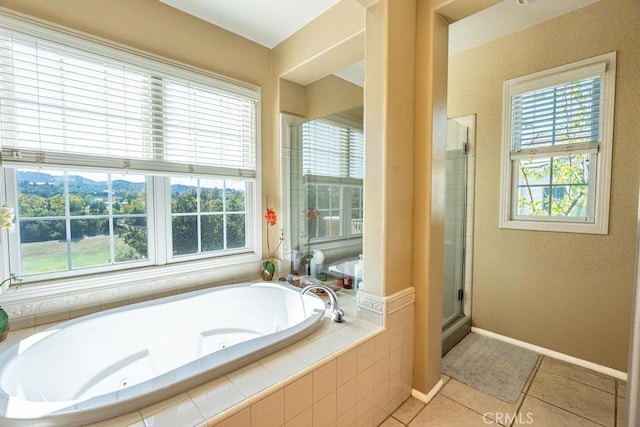 bathroom with tile patterned floors and shower with separate bathtub