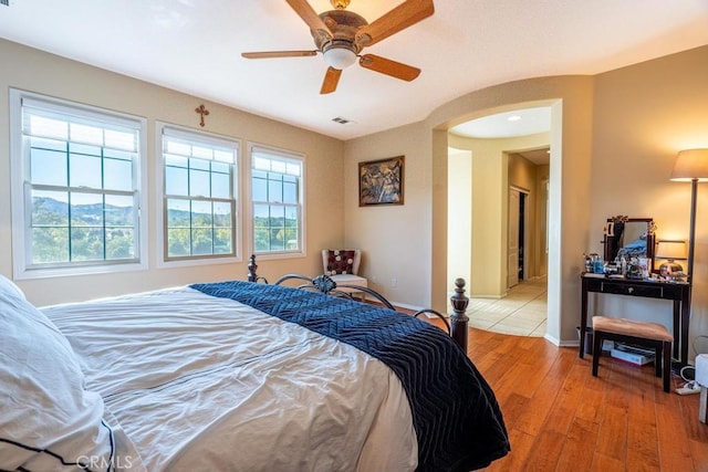 bedroom with ceiling fan and light wood-type flooring