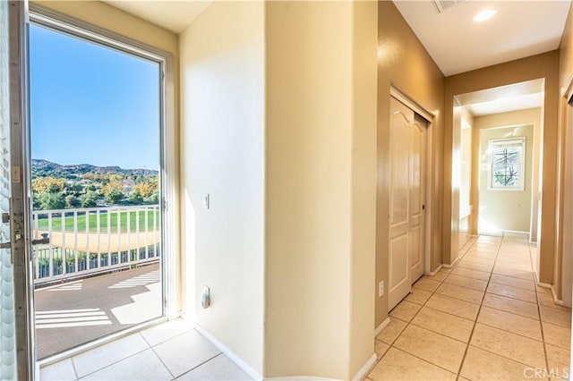 doorway featuring plenty of natural light, a mountain view, and light tile patterned floors