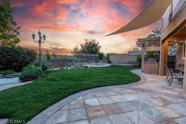 yard at dusk with a patio area