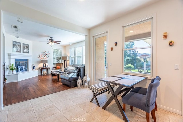 dining area with ceiling fan and light wood-type flooring