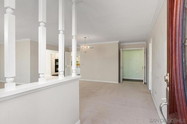 interior space with light carpet, a textured ceiling, a chandelier, and crown molding