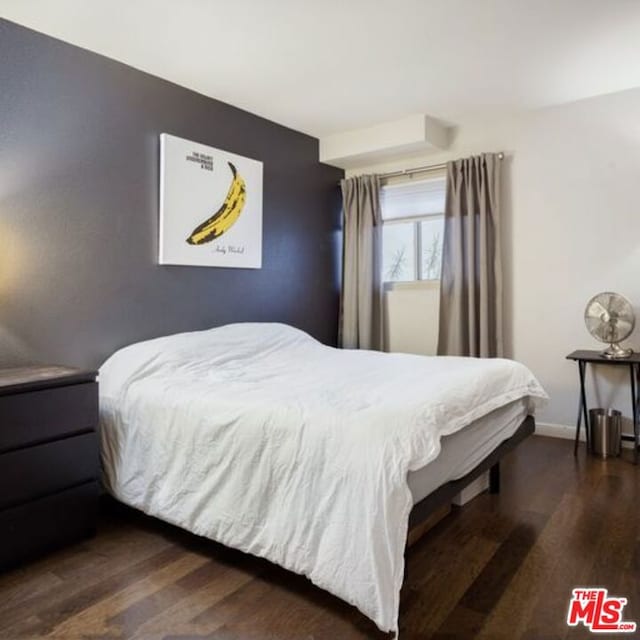 bedroom with dark hardwood / wood-style flooring