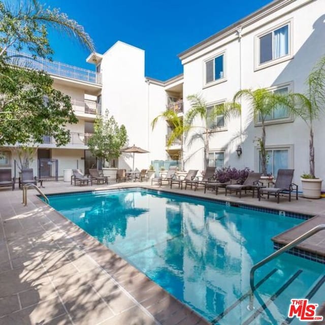 view of swimming pool featuring a patio area