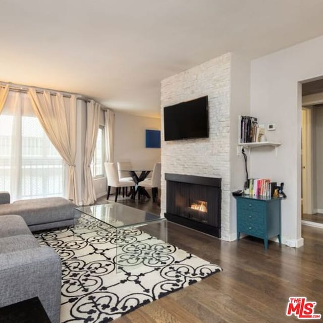 living room featuring a fireplace and dark hardwood / wood-style flooring