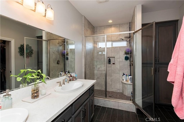 bathroom with vanity and a shower with shower door