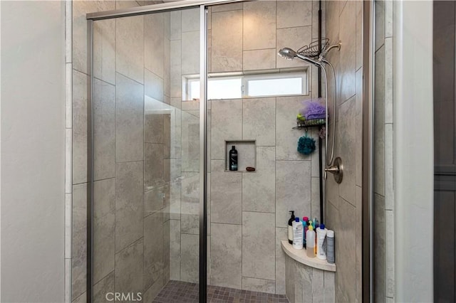 bathroom featuring a shower with door