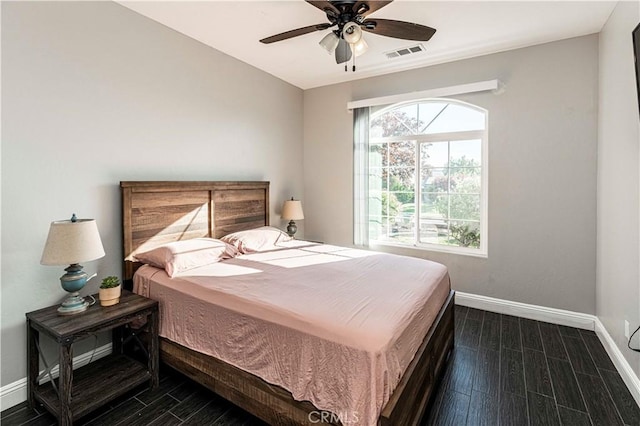 bedroom with ceiling fan and dark hardwood / wood-style floors